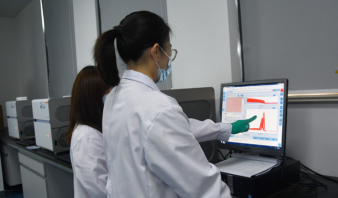 Two female scientists reviewing results n a computer screen