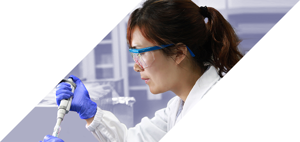 Female scientist with purple gloves fills vials